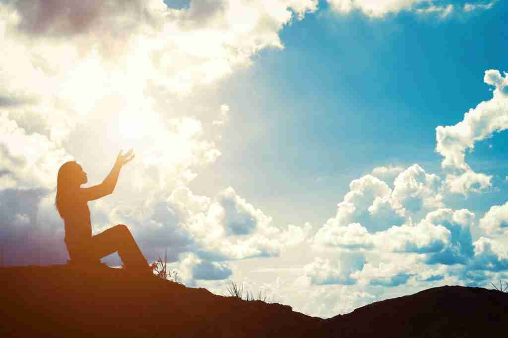 silhouette woman with raised hands