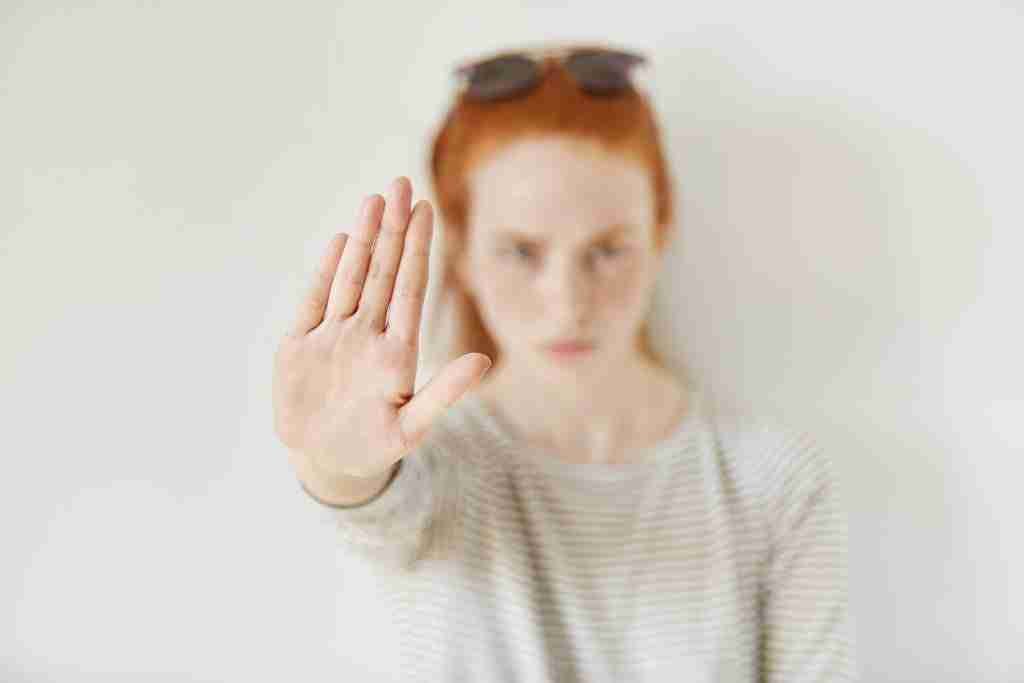 Why The Grey Rock Method Will Help You To Deal With Your Ex But It Will Not Help You To Heal Your Wounds 2 young annoyed woman with bad attitude making stop gesture with her palm outward saying no expressing denial restriction negative human emotions feelings body language selective focus hand