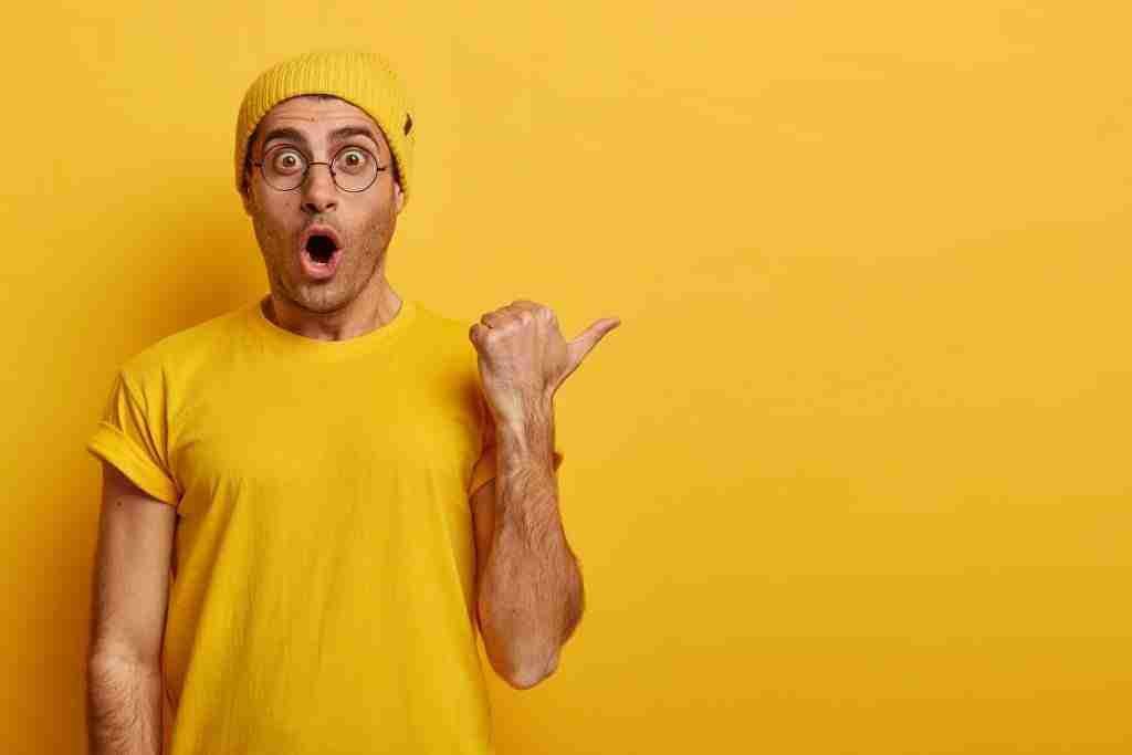 5 Beliefs That Keep You Disempowered 2 wow huge discount opportunity emotive guy with terrified face expression demonstrates unexpected opportunity points thumb right blank space wears yellow outfit advertisement