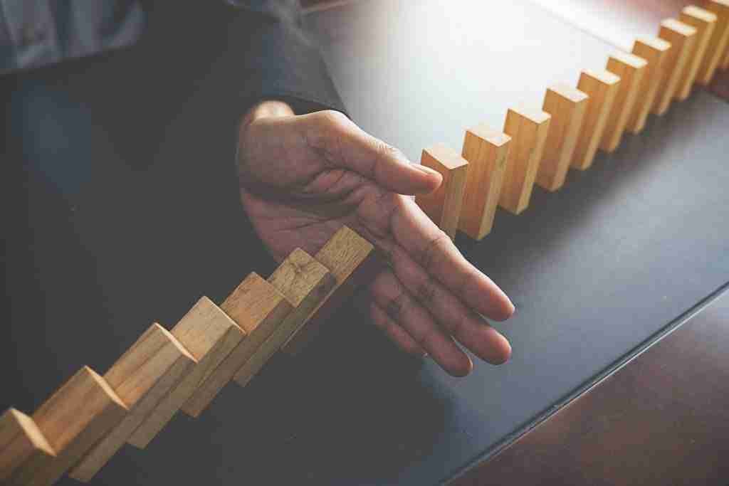 3 Steps To Create Lasting Change In Your Life 1 a hand stopping blocks from falling