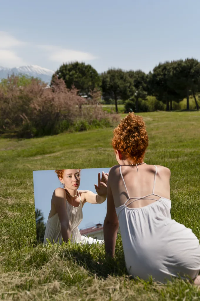 How to Cultivate Self-Love and Acceptance - A Guide for Professional Women 1 young woman posing mirror grass outdoors