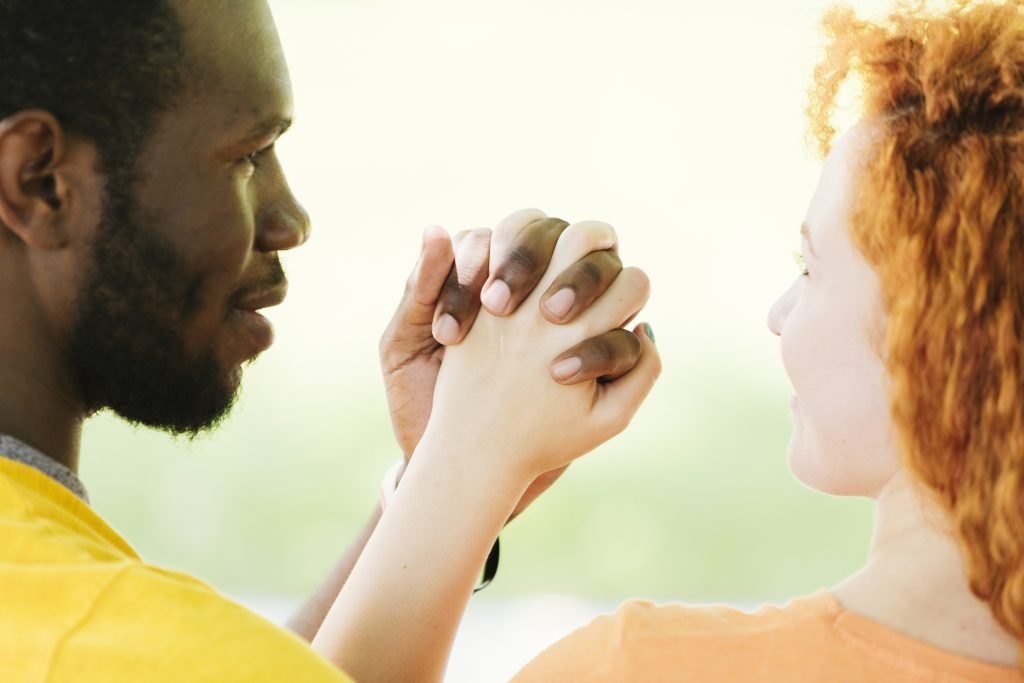 How Mindfulness Strengthens Relationships 1 close up interracial couple holding hands