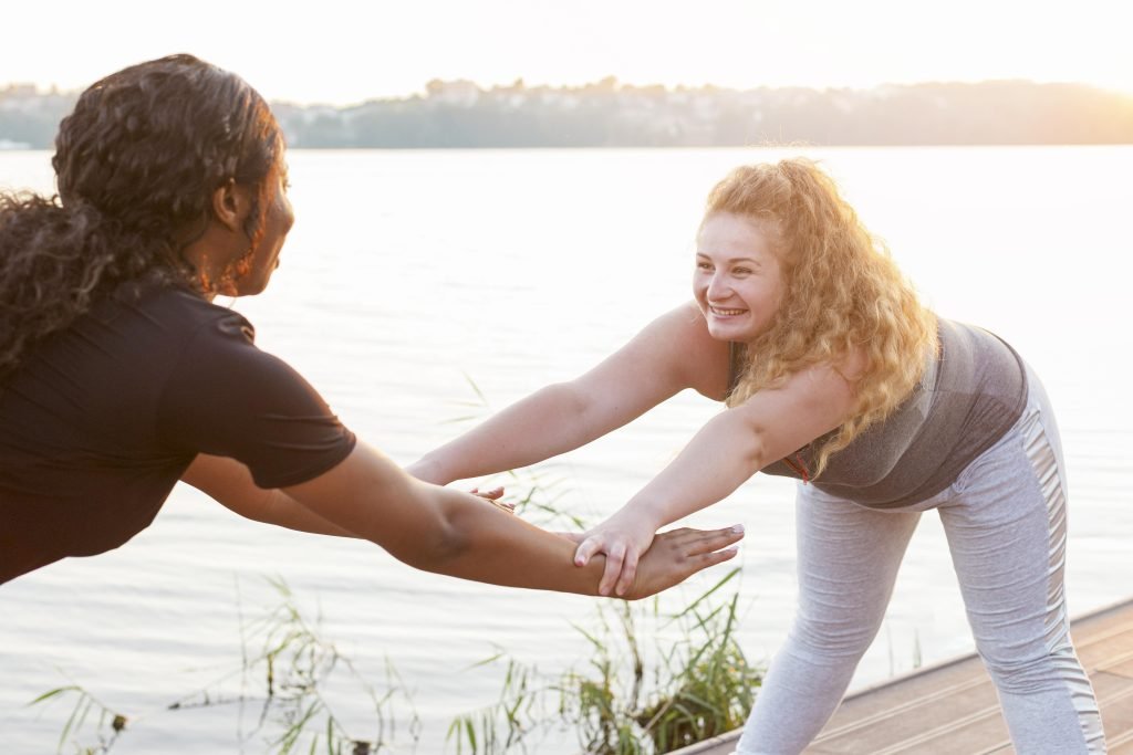 How Mindfulness Strengthens Relationships 2 female friends training together
