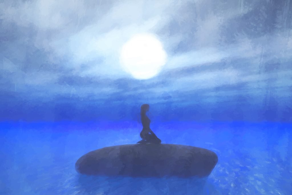 The Role of Mindfulness in Spiritual Awakening 1 A woman practicing mindfulness on a rock