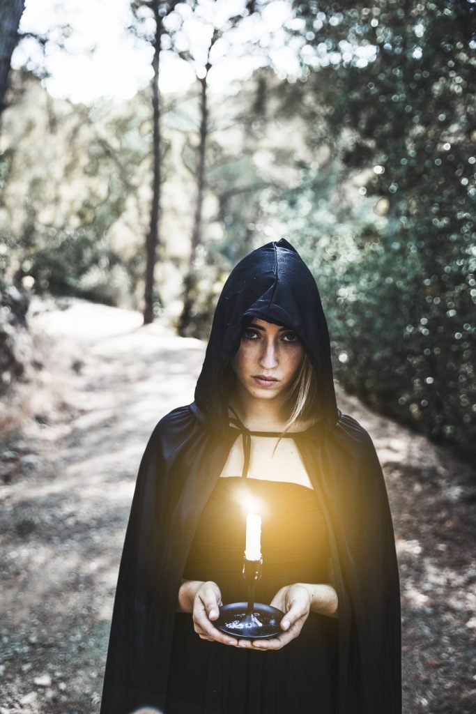 Overcoming Fear and Doubt During Spiritual Awakening 3 A woman using the light of a candle to guide her
