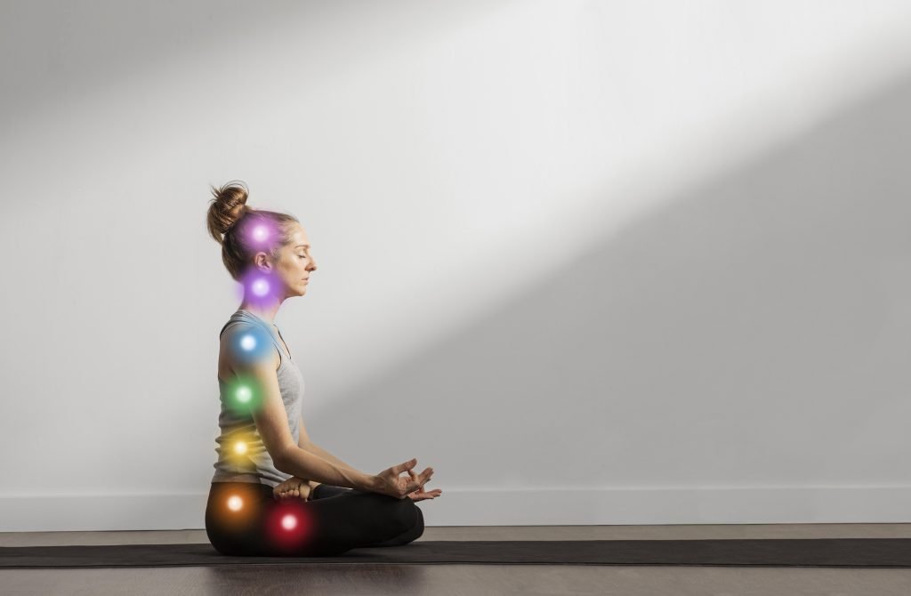 A woman aligning her chakras through meditation