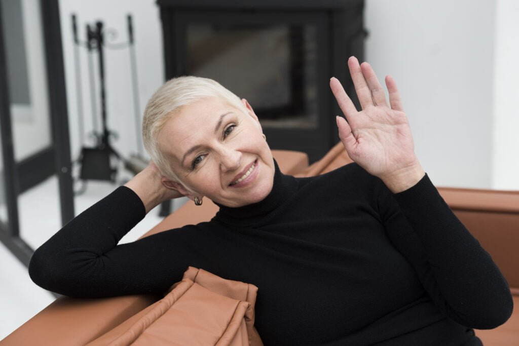 Navigating Midlife with Self-Love - Tips for Women Over 40 2 front view happy mature woman posing waving while smiling