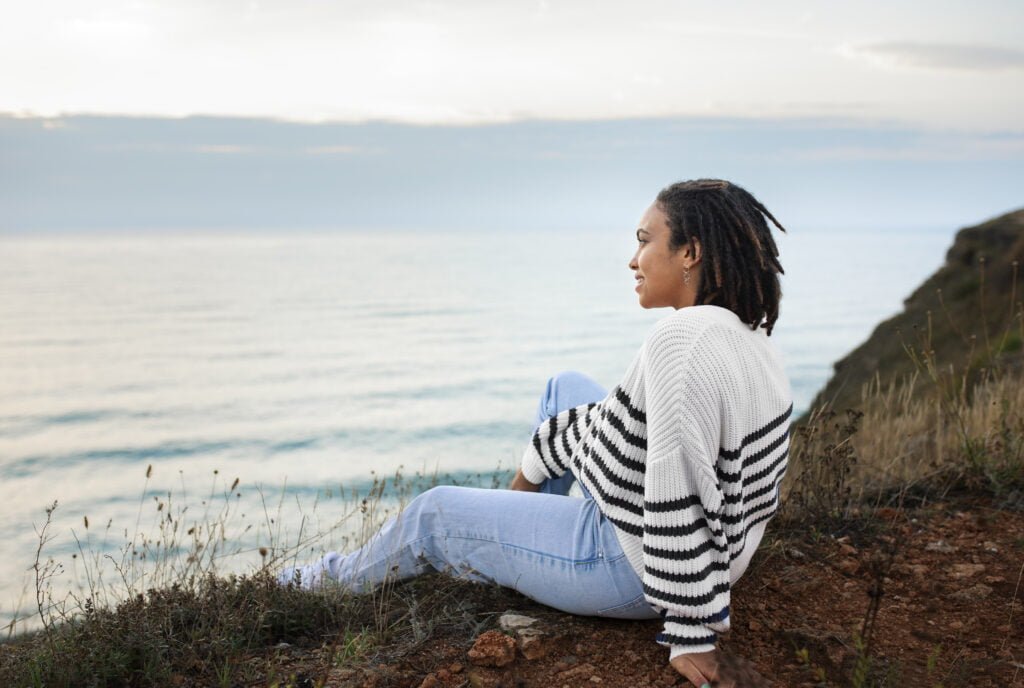 Mindfulness and Self-Love - Techniques to Enhance Your Inner Peace 2 A woman practicing mindfulness and self-love at the seaside
