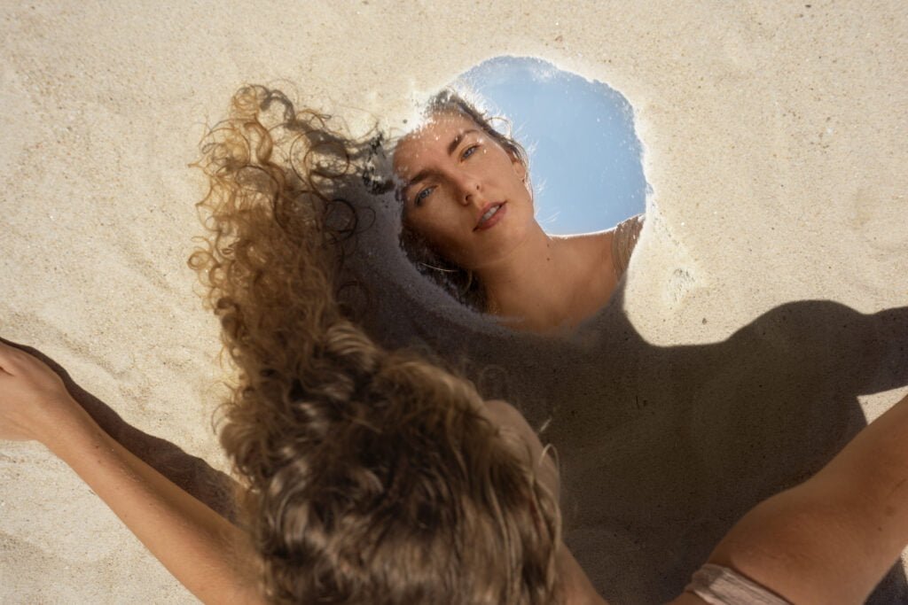 10 Daily Practices to Boost Your Self-Love and Confidence 1 A woman practising self-love with her reflection