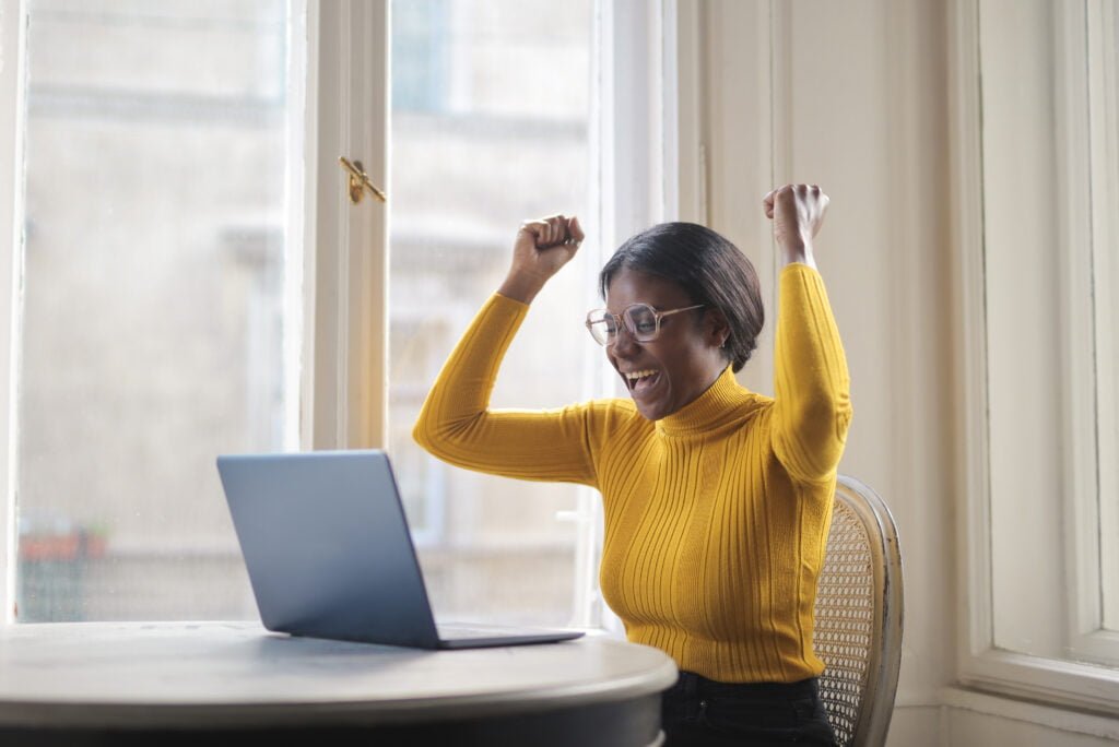 How to Celebrate Your Achievements and Boost Self-Love 1 A black woman celebrating an achivement