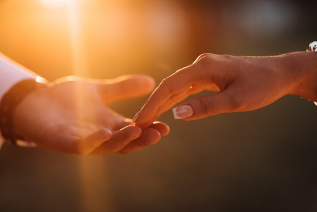 Using the Law of Attraction to Improve Your Relationships 1 Two people reaching out to each other in a trustworthy relationship