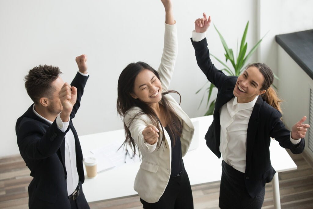 How to Celebrate Your Achievements and Boost Self-Love 3 Office workers performing a victory dance
