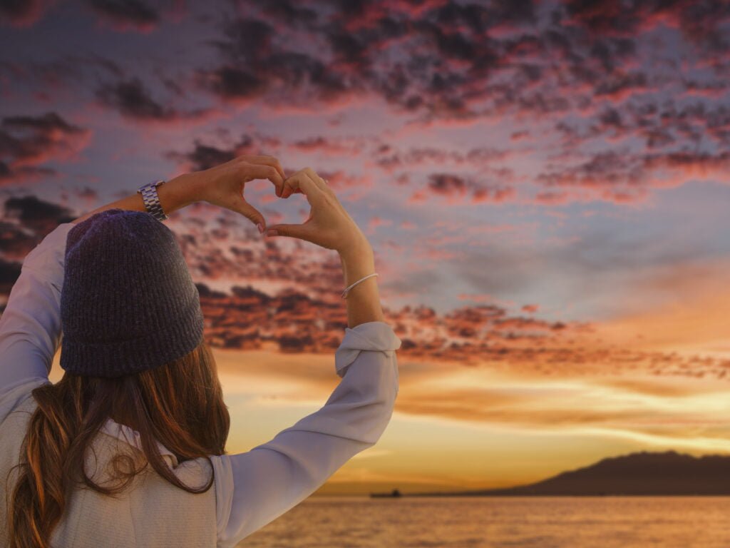 The Law of Attraction and Self-Love - Building a Foundation for Success 1 A woman showing love to the herself and the Universe
