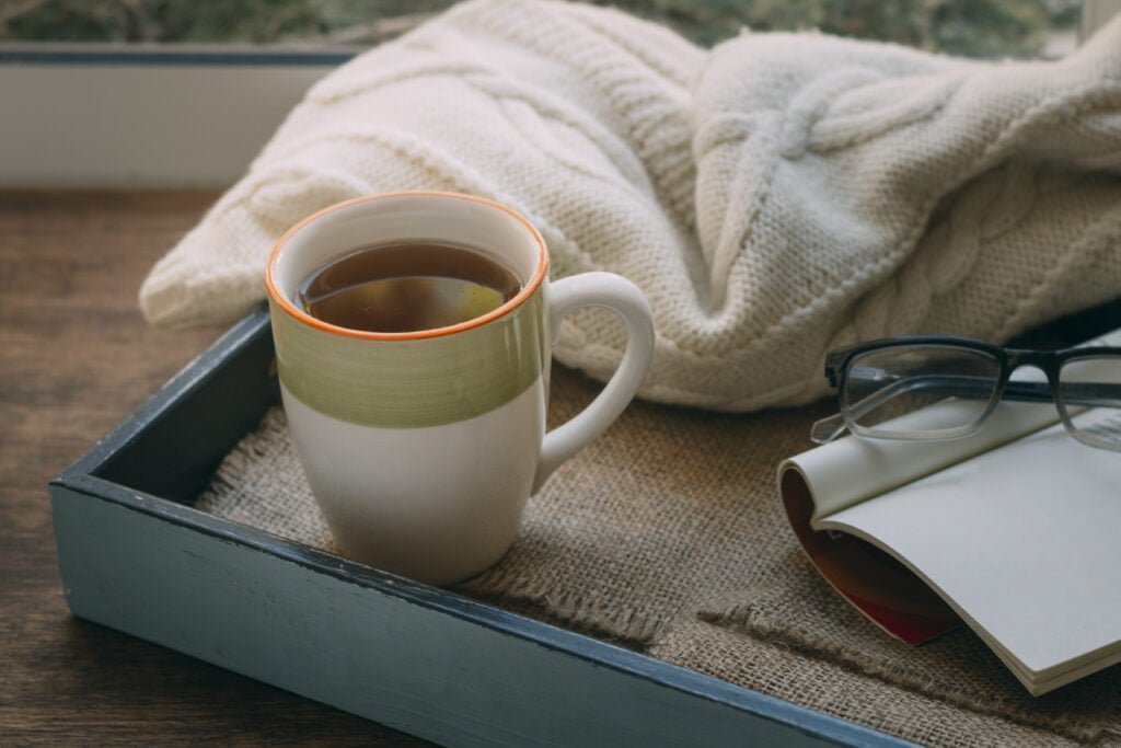 How to Create a Morning Routine That Supports Your Manifestation Practice 1 Morning set up with a cup of tea and a journal
