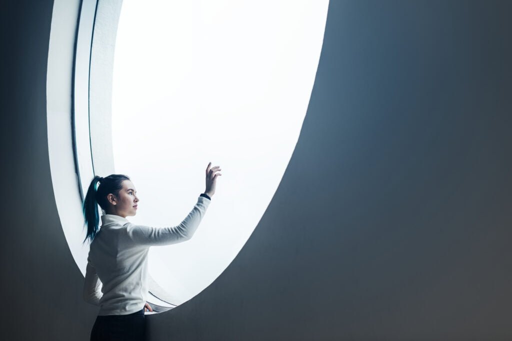 From Thoughts to Reality - The Process of Manifestation Explained 1 A young woman reaching out to her dreams