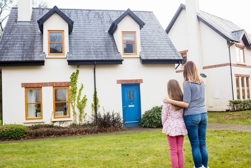 How to Use the Law of Attraction to Manifest Your Dream Home 4 Mother and daughter standing in front of their dream home