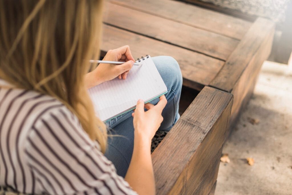 Using the 5x55 Method for Rapid Manifestation 3 A woman writing with her non-dominant hand