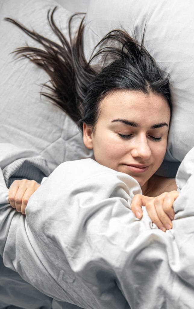 Manifesting Better Sleep and Rest Using the Law of Attraction 6 A woman blissfully asleep
