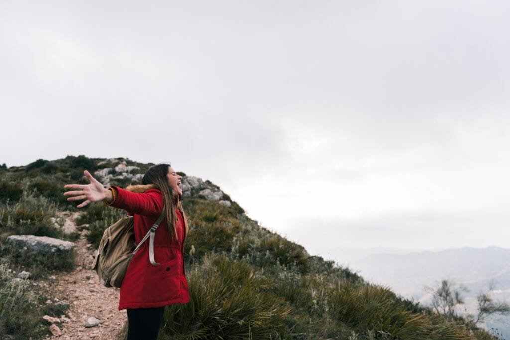 Manifesting Travel and Adventure - Using the Law of Attraction for Experiences 2 A woman feeling freedom while travelling
