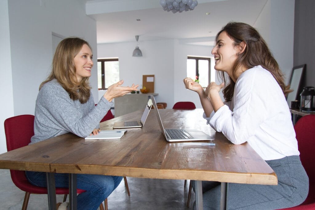 How to Use the Law of Attraction to Improve Your Communication Skills 1 two women in an engaging communication