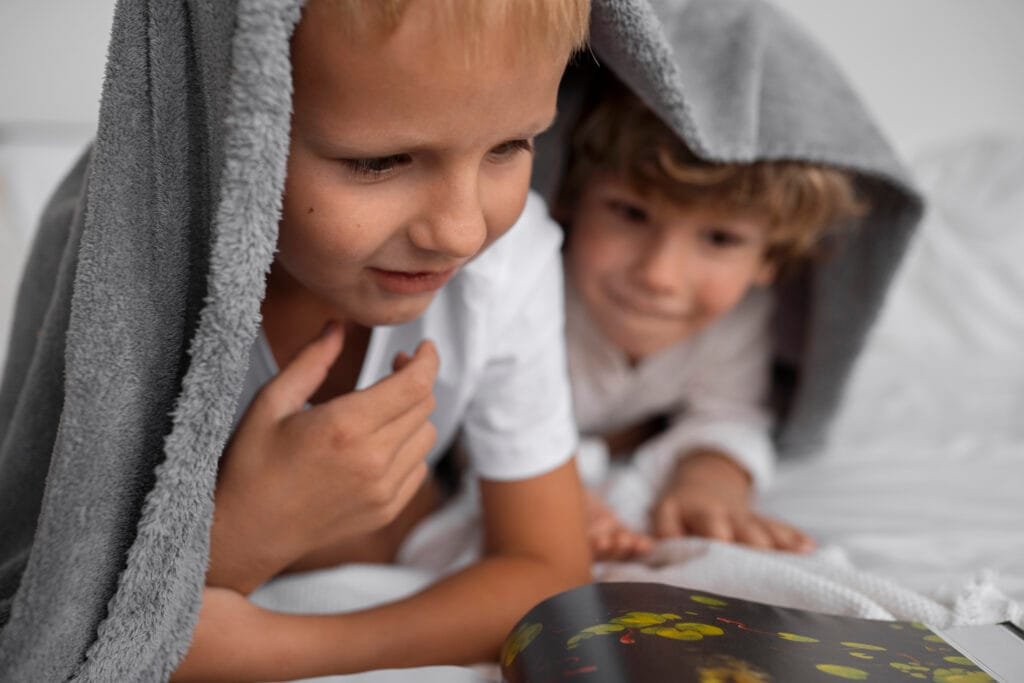 Two brothers reading a book before sleep
