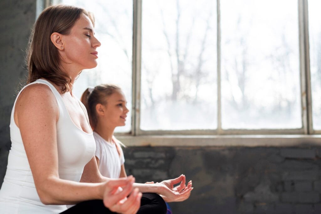 5 Mindful Breathing Techniques to Stay Calm as a Parent 1 a mother and daughter practicing mindful breathing