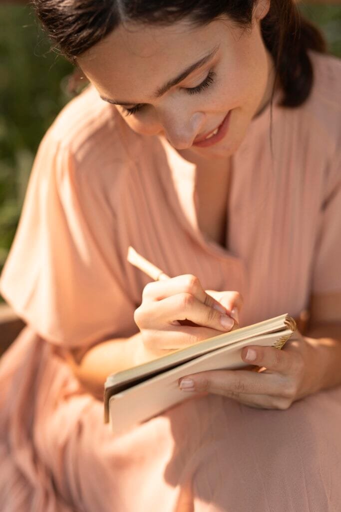 A woman rewriting her story in her journal